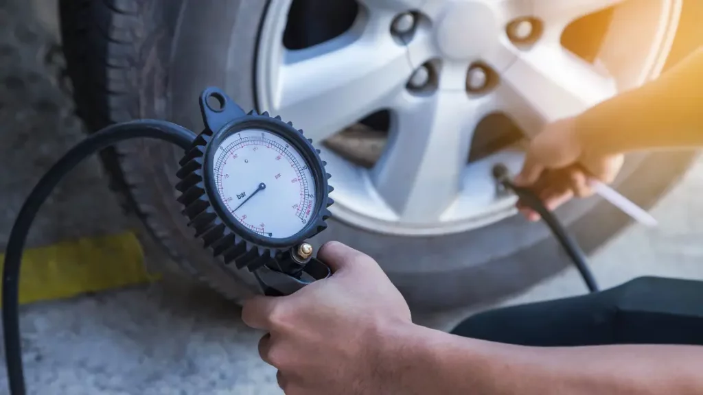 checking tyre pressure before a road trip