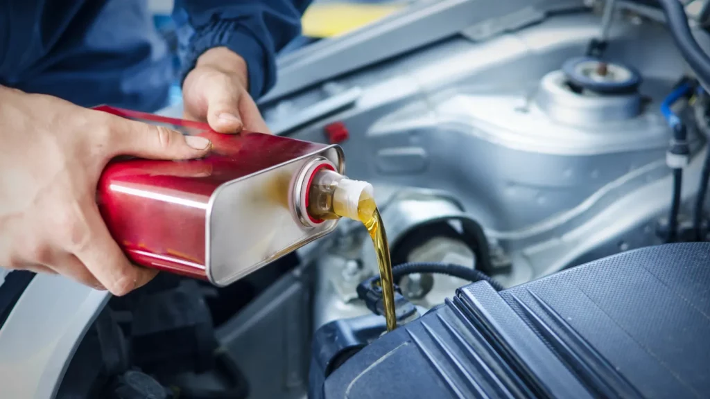 Topping up oil during car servicing