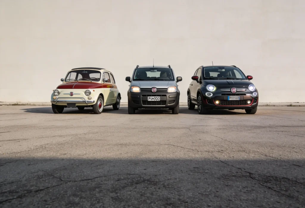 Historic Fiat models displayed together, including a classic Fiat 500, a late-1990s Fiat hatchback, and a modern Fiat model, showing the evolution of Fiat’s practical design.