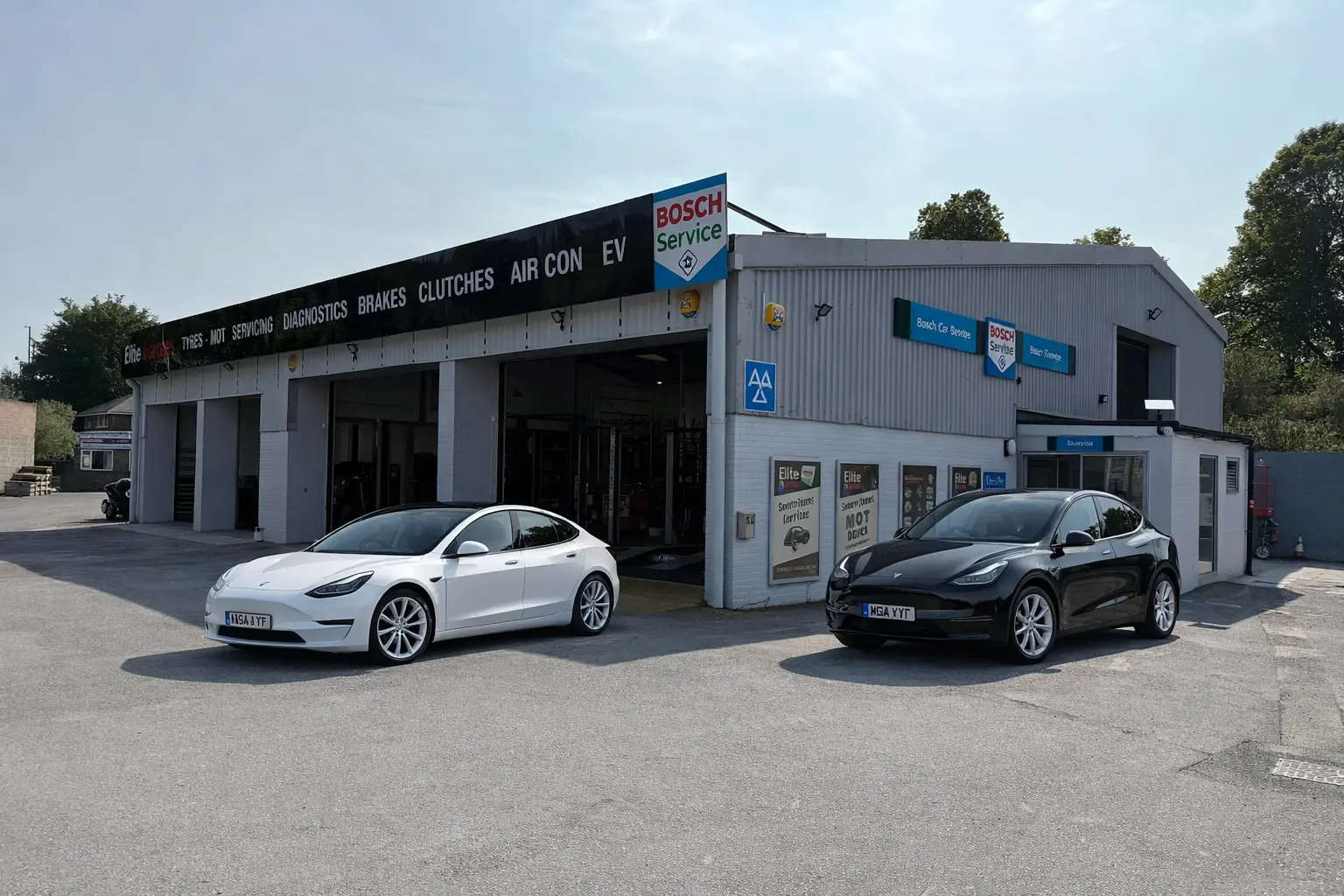 Tesla Model 3 and Tesla Model Y parked outside Elite Garages, highlighting professional Tesla services in the UK