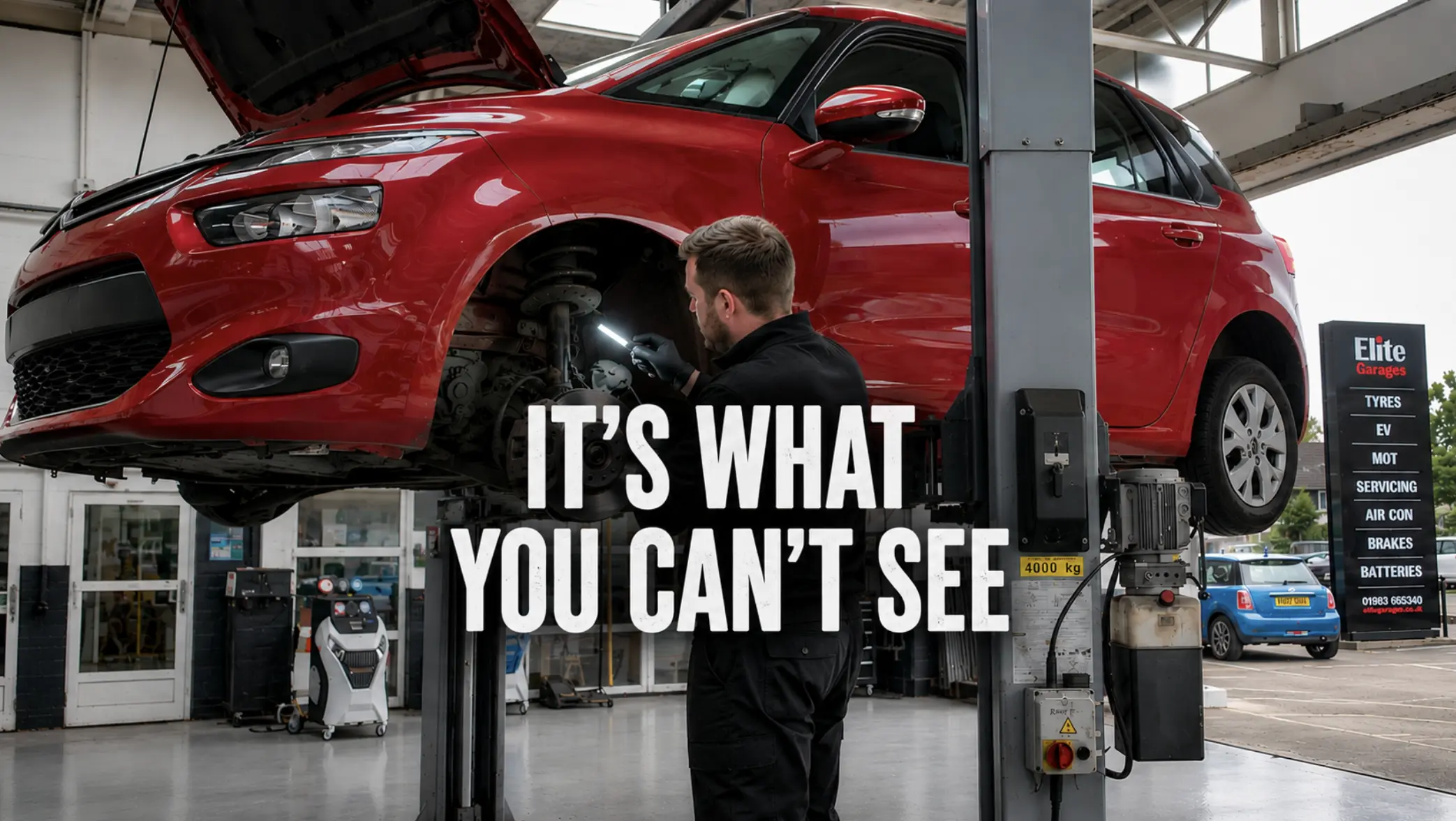Technician inspecting the front suspension and steering components of a vehicle on a workshop lift after suspected pothole damage.